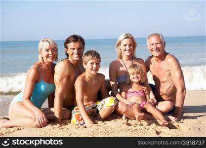 Three generation family pose on beach