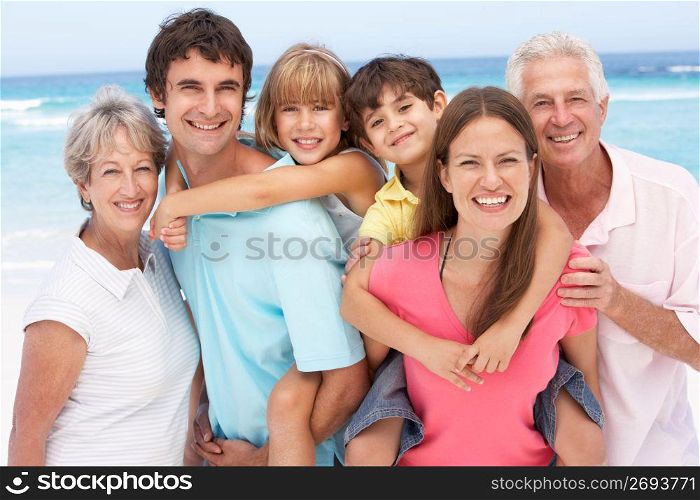 Three Generation Family Relaxing On Beach Holiday