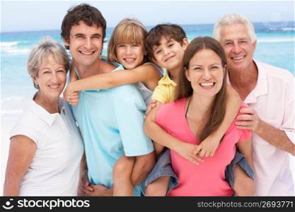 Three Generation Family Relaxing On Beach Holiday