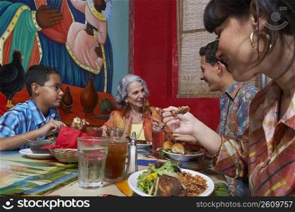 Three generation family taking food in a restaurant