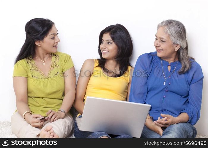Three generational family discussing while shopping online