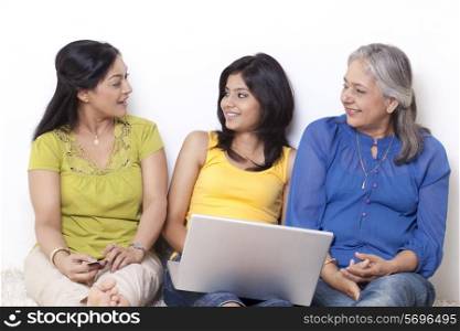 Three generational family discussing while shopping online