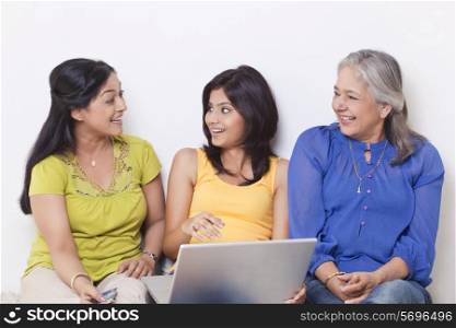 Three generational family talking while shopping online