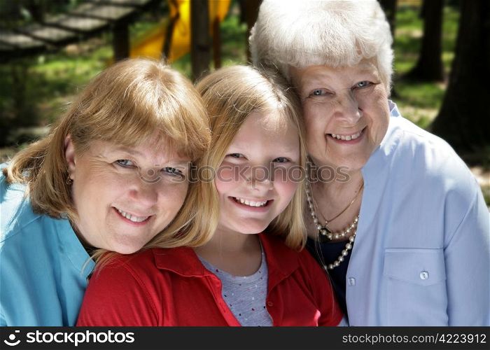 Three generations, a grandmother, mother, and daughter in the park.
