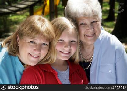 Three generations, a grandmother, mother, and daughter in the park.
