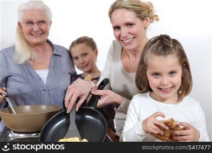 Three generations cooking pancakes