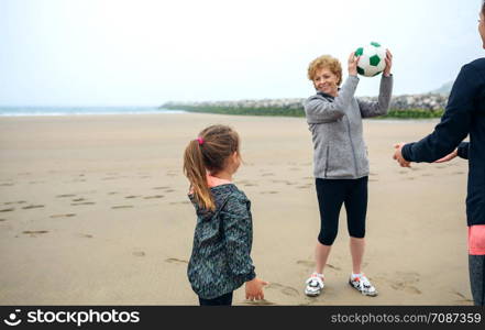 Three generations female playing on the beach in autumn. Three generations female playing on the beach