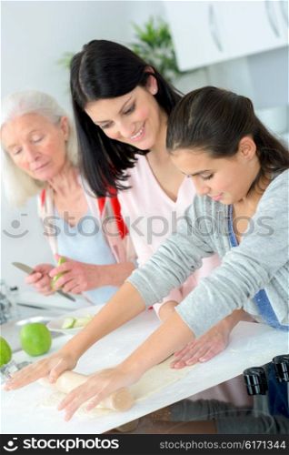 Three generations of women baking together