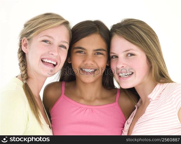 Three girl friends together smiling