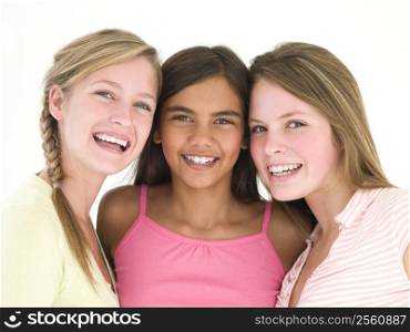 Three girl friends together smiling