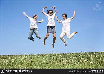 Three girlfriends in white T-shorts jump simultaneously