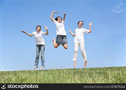 Three girlfriends in white T-shorts jump together
