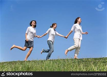 Three girlfriends in white T-shorts together run