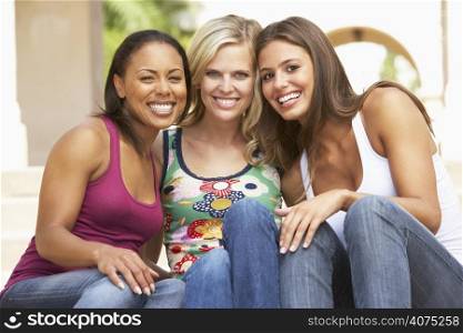 Three Girlfriends Sitting On Steps Of Building