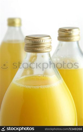 Three glass bottles of fruit juice