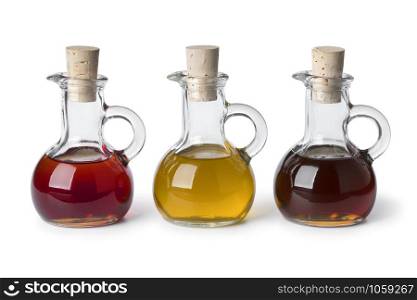 Three glass bottles with different types of cooking oil isolated on white background