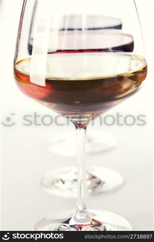 Three glass of wine (white, red and rose) over white