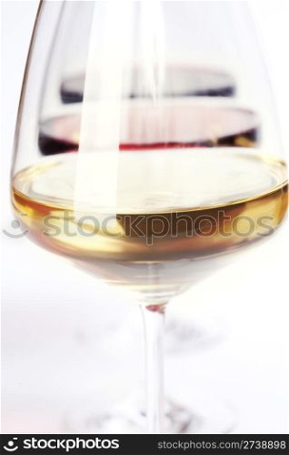 Three glass of wine (white, red and rose) over white