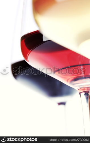 Three glass of wine (white, red and rose) over white