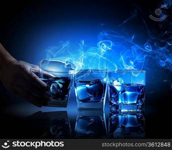 Three glasses of blue cocktail with fume going out