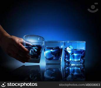 Three glasses of blue liquid. Image of three glasses of blue liquid with ice