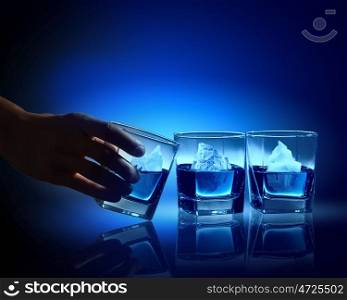 Three glasses of blue liquid. Three glasses of blue liquid with icebergs in