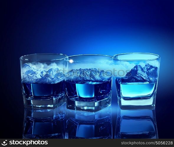 Three glasses of blue liquid. Three glasses of blue liquid with mountain illustration in