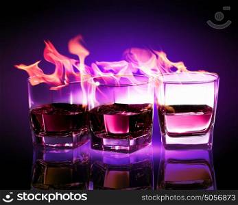 Three glasses of burning purple absinthe. Image of three glasses of burning puple absinthe