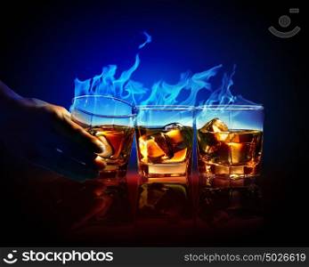 Three glasses of burning yellow absinthe. Image of three glasses of burning yellow absinthe