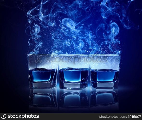 Three glasses of cocktail. Three glasses of cocktail with fumes and falling snow