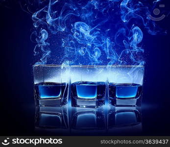 Three glasses of cocktail with fumes and falling snow