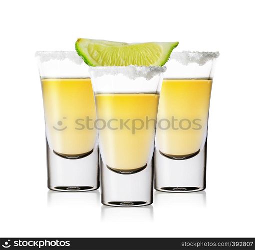 Three glasses of golden tequila with salt and lime isolated on white background. Traditional Mexican strong alcoholic drink.. Three glasses of golden tequila with salt and lime