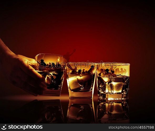 Three glasses of whiskey. Hand holding one of three glasses of whiskey with ice and party illustration in
