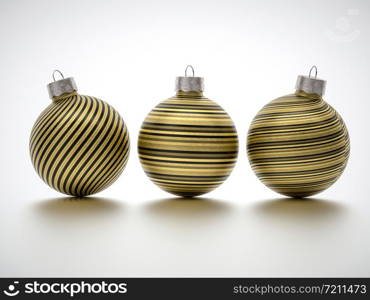 Three gold Christmas ball decorations with twirled stripes and glitter texture on white with shadow and copy space for your seasonal holiday greeting