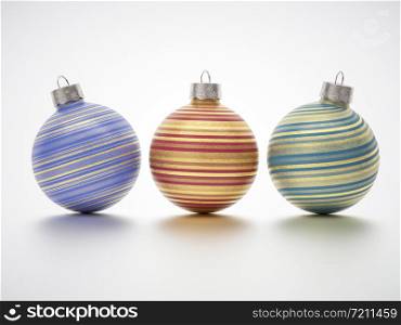 Three gold streaked Christmas balls with twirled stripes and glitter texture on white with shadow and copy space for your seasonal holiday greeting. With Floor Reflection.