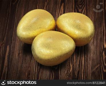 Three golden Easter eggs isolated on wooden background. Golden Easter eggs