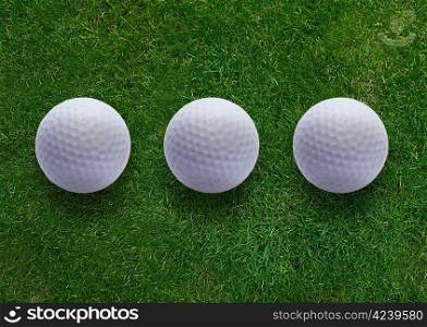 Three golf ball on green grass land .