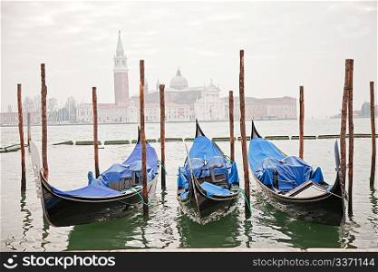 Three gondolas in Venice at the pier