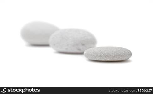 Three gray spa stones on white background