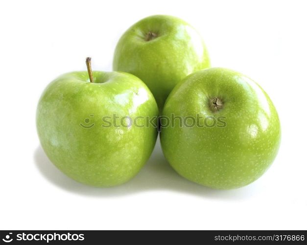 Three green apples isolated on white background
