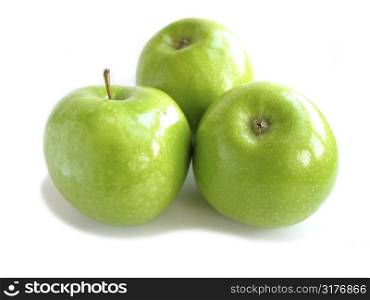 Three green apples isolated on white background