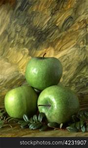 Three green apples on painted background