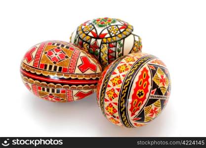 three hand painted eggs over white background