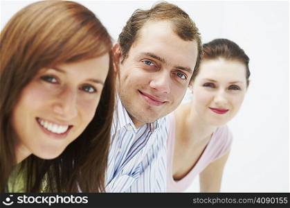 Three happy people, looking at camera