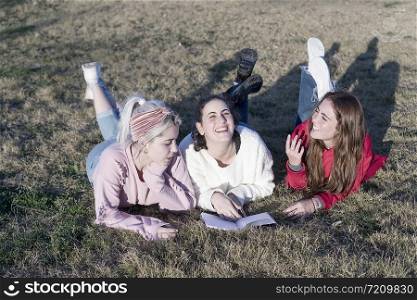 Three happy teenage friends having fun in spring park