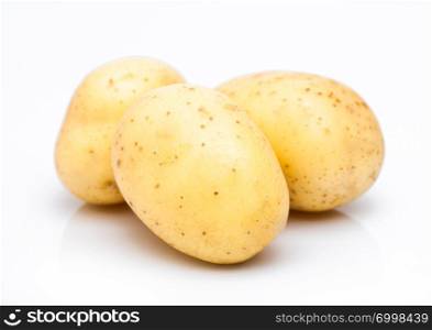 Three healthy organic baby potatoes on white.