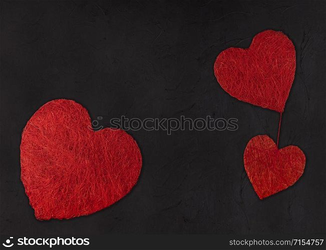 Three hearts of different size on a black background. valentines day concept