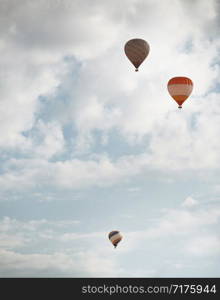 Three hot air balloons flying in the sky