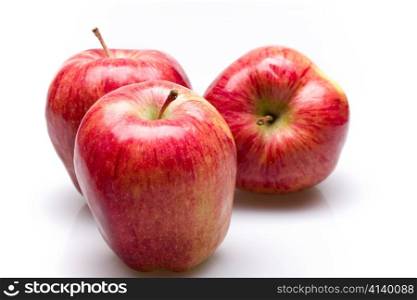 Three juicy apples lay in a number on white background