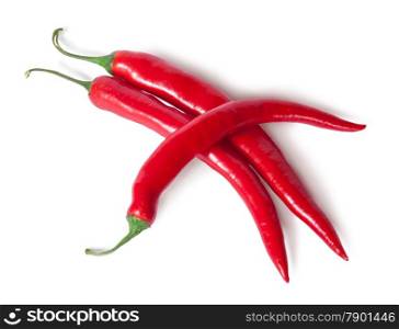 Three juicy red ripe sharp intersecting chili peppers isolated on white background